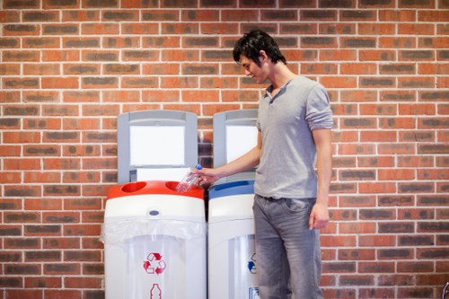 A sustainable rubbish area setup showing separated bins for paper, glass, food waste and WEEE